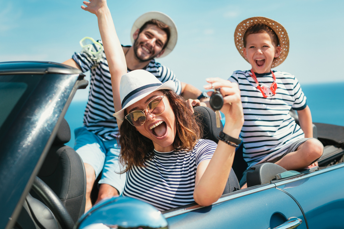 Happy family travel by car to the sea.